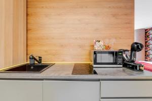 a kitchen with a sink and a microwave at SPA apartments in city centre in Vilnius