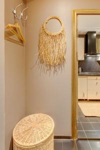 a wicker chandelier in a kitchen with a stool at SPA apartments in city centre in Vilnius +41 photos
