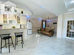 a kitchen and a living room with a table and chairs at Ag ev in Mekhrably +21 photos
