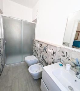 a bathroom with a toilet and a sink and a shower at B&b Ranieri in Le Castella +32 photos