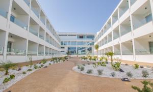 an external view of a building with a courtyard at Nicholas Color Hotel in Ayia Napa