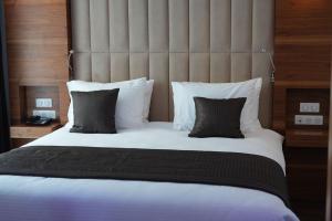 a bedroom with a large bed with a large headboard at El-Arz Hotel in Boghni +17 photos
