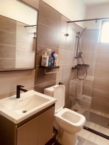 a bathroom with a sink and a toilet and a mirror at Nash Residence in Marimbeti