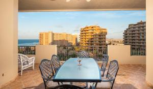 a table and chairs on a balcony with a view of the ocean at Bella Sirena BA 505 As Good As It Gets Beautiful Ocean View Condo in Puerto Peñasco