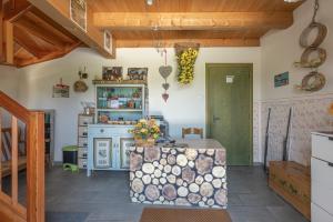 a kitchen with a table in a room with wooden ceilings at Agriturismo Filippon  +36 photos