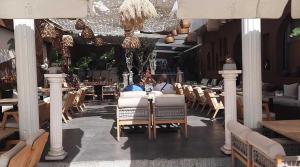 a restaurant with chairs and a table in a room at Tosunpasa Cafe Otel in Bodrum City