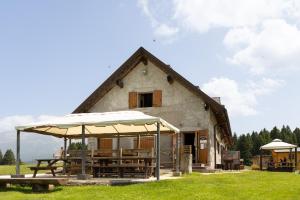 a building with tables and umbrellas in front of it at Agriturismo Filippon 