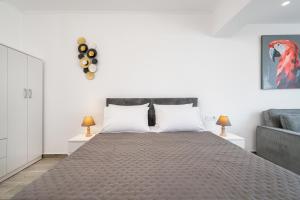 a bedroom with a large bed with two lamps at Kos Mare - Elegant Beachfront Stay in Paradeísi +29 photos