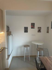 a kitchen with two tables and a refrigerator at Club4C Apartman in Makó