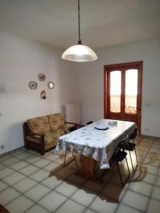 a living room with a table and a couch at La casa di Titta in Faggiano