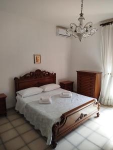 a bedroom with a large bed with two towels on it at La casa di Titta in Faggiano +5 photos