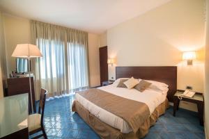 Postel nebo postele na pokoji v ubytování Hotel La Lucertola