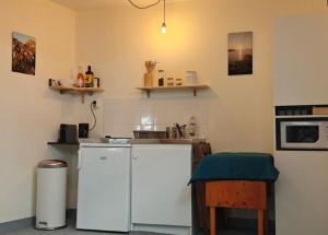 a kitchen with a white refrigerator and a stove at Le belvédère de Glazen in Douarnenez