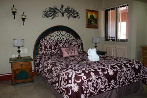a bedroom with a large bed with a brown and white bedspread at Marina Pinacate in Puerto Peñasco +17 photos