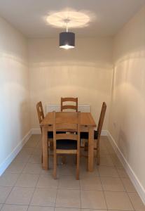 a dining room with a wooden table and chairs at West Beach - Holiday Apartments in Westward Ho