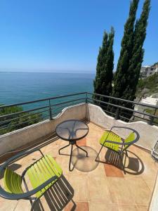 a patio with two chairs and a table on a balcony at TALi in Ulcinj