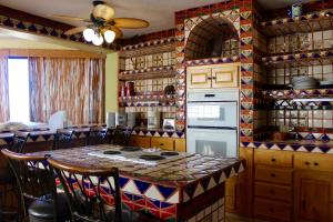 a kitchen with a table and a stove top oven at Las Gaviotas 402 Mid-century Ocean View Apartment in Puerto Peñasco