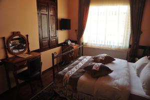 Postel nebo postele na pokoji v ubytování Aksehir Butik Hotel