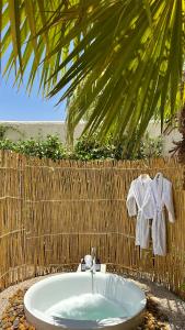 a bathroom with a bath tub with a palm tree at شاليه فندقي غرفتين نوم مسبح وبانيو in Banī Ma‘n