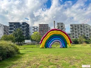a large rainbow tent in a field in a city at Gorgeous duplex near top attractions in Saint-Ouen