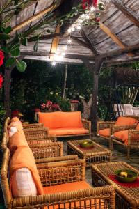 an outdoor patio with wicker chairs and a pergola at Apartamentos Rurales & Spa La Bárcena in Enterria