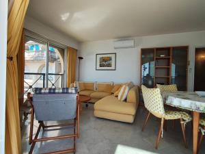 a living room with a couch and a table and chairs at Victoria Sea in Menton