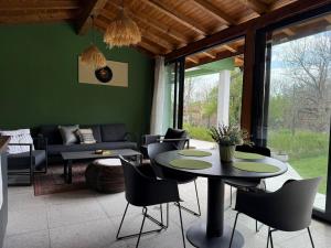 a living room with a table and chairs at Villa Green House in Tscherweni Breg