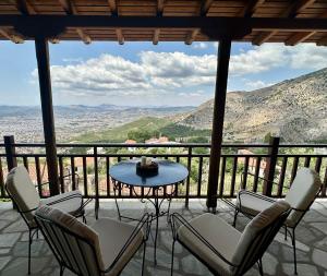 a balcony with chairs and a table and a view at Stagiates House in Stagiates