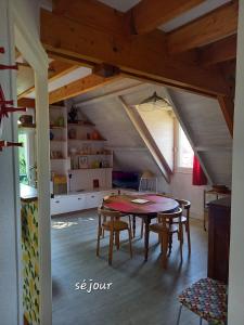 a dining room with a table and some chairs at Au Numéro 20 in Tournon-Saint-Pierre