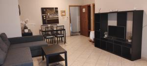 a living room with a couch and a tv at Vania's apartment in Preveza
