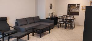 a living room with a couch and a table and chairs at Vania's apartment in Preveza +18 photos