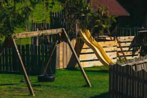 a swing set in a yard next to a fence at Happis Fassle in Tarrenz
