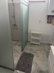 a bathroom with a shower and a glass door at Bel horizon in Collo