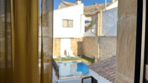 a view of a swimming pool from a window at Hotel Rosaleda Don Pedro in Úbeda