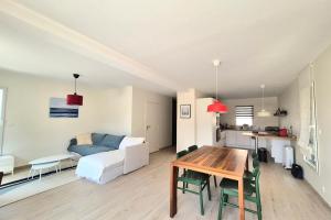 a living room with a table and a couch at Superb house with garden - Saint-Coulomb in Saint-Coulomb
