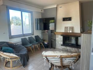 a living room with a couch and a fireplace at Maison a étages bord de mer in Notre-Dame-de-Monts