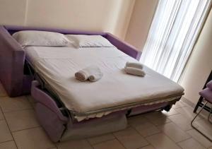 a bed with two towels on it in a room at BnB Cairoli - Homezon in Diano Marina