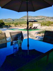 a table with an umbrella on top of it at Prominska Bajka in Razvođe