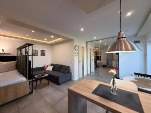 a living room with a couch and a table at Apartamenty Mariańska 103 in Racibórz