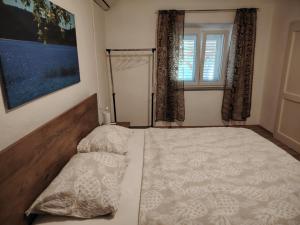 a bedroom with a large bed and a window at Prominska Bajka in Razvođe +30 photos