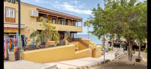 a yellow building on the side of a street at Azure Bliss in Costa de Adeje