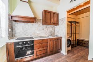 a kitchen with wooden cabinets and a stove top oven at Diana 1 Apartment the Green Zone of Florence in Florence