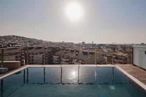 a swimming pool on top of a building at Catalonia Park Putxet in Barcelona