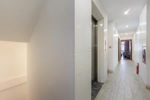 a hallway with white walls and a white floor at Dancenter Near Hoan Kiem Lake, Old Quarter formerly Le Grand The Tryst in Hanoi