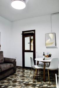 a living room with a table and a couch at Casa Agustina in Arguineguín +40 photos