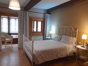 a bedroom with a white bed in a room at Casa Cotiellu in Llanes