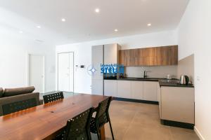 a kitchen and dining room with a wooden table at Condominio Vittoria in Lido di Jesolo