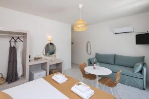 a living room with a couch and a table at Palos Luxury Suites in Kini