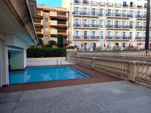 a swimming pool in front of a building at Victoria Sea in Menton