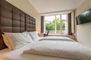 Postel nebo postele na pokoji v ubytování Pakat Residences